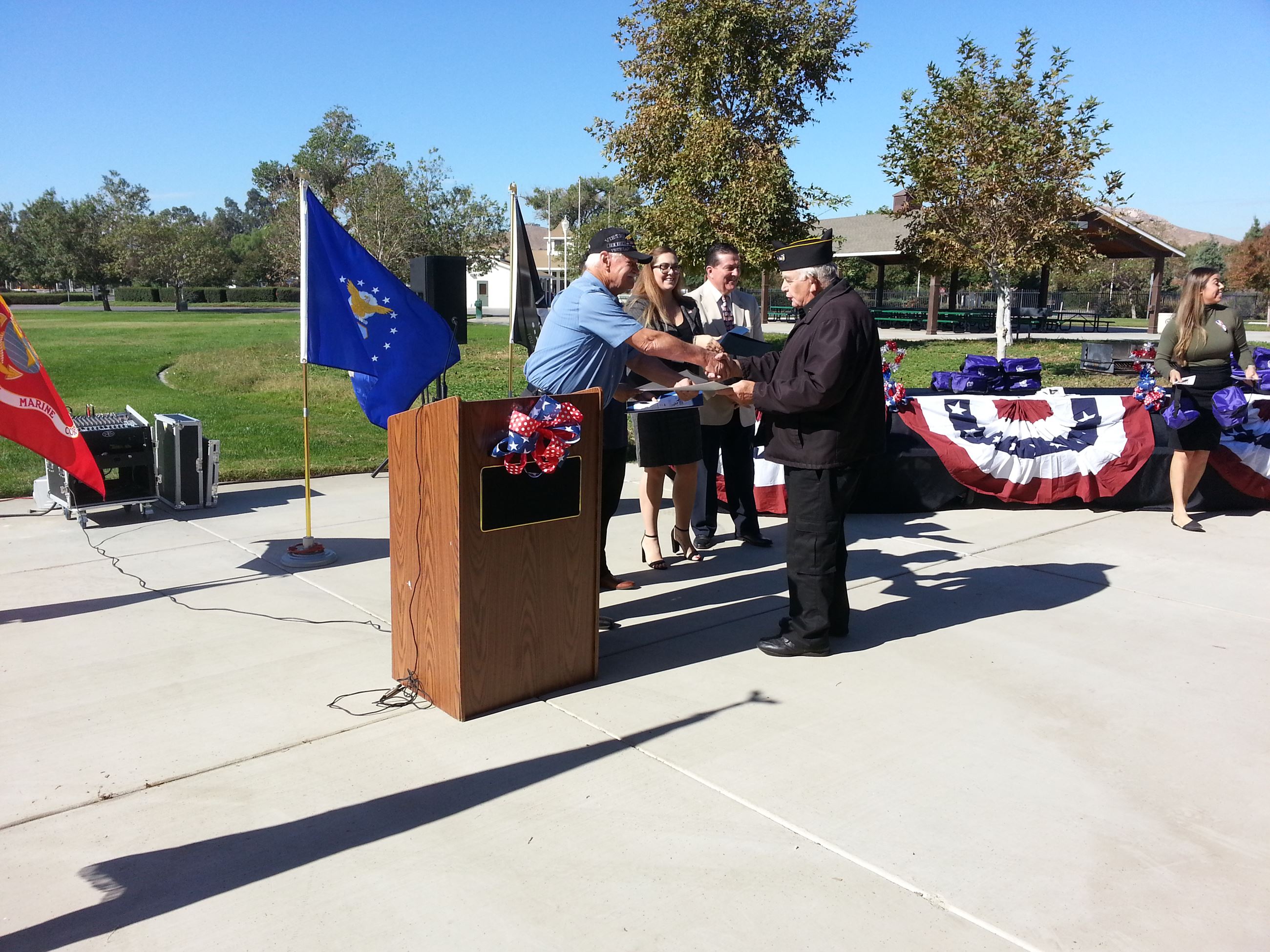 Man Shakes Hand With Another Man in Military Uniform at Celebrating Veterans Event